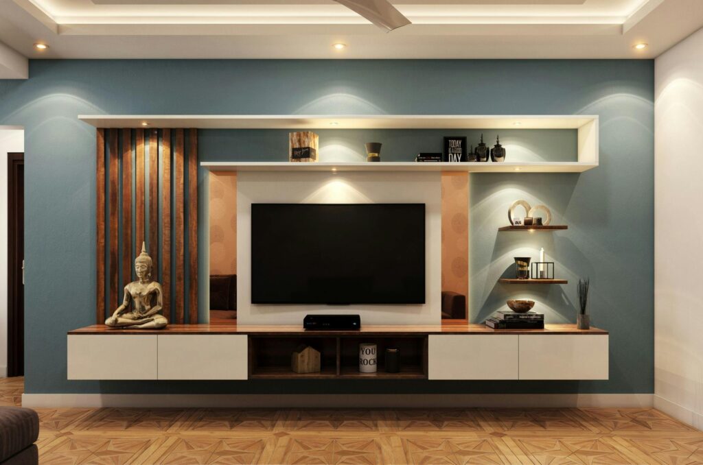Elegant minimalist living room with TV, decorative shelves, and Buddha statue for serene ambiance.